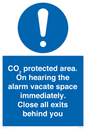 MN7906: CO₂ protected area. On hearing the alarm vacate space immediately. Close all exits behind you