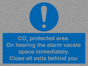MN7906: CO₂ protected area. On hearing the alarm vacate space immediately. Close all exits behind you