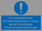 MN7906: CO₂ protected area. On hearing the alarm vacate space immediately. Close all exits behind you
