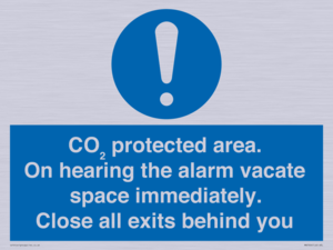 MN7906: CO₂ protected area. On hearing the alarm vacate space immediately. Close all exits behind you