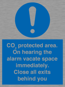 MN7906: CO₂ protected area. On hearing the alarm vacate space immediately. Close all exits behind you