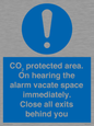 MN7906: CO₂ protected area. On hearing the alarm vacate space immediately. Close all exits behind you