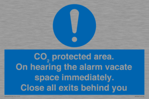 MN7906: CO₂ protected area. On hearing the alarm vacate space immediately. Close all exits behind you