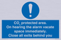 MN7906: CO₂ protected area. On hearing the alarm vacate space immediately. Close all exits behind you