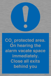 MN7906: CO₂ protected area. On hearing the alarm vacate space immediately. Close all exits behind you