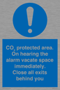 MN7906: CO₂ protected area. On hearing the alarm vacate space immediately. Close all exits behind you