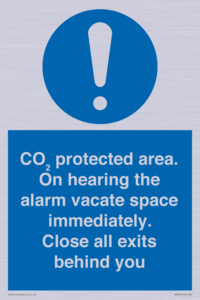 MN7906: CO₂ protected area. On hearing the alarm vacate space immediately. Close all exits behind you