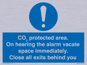 MN7906: CO₂ protected area. On hearing the alarm vacate space immediately. Close all exits behind you