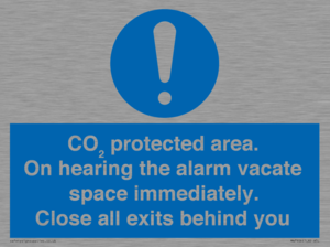 MN7906: CO₂ protected area. On hearing the alarm vacate space immediately. Close all exits behind you
