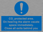 MN7906: CO₂ protected area. On hearing the alarm vacate space immediately. Close all exits behind you