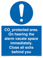 MN7906: CO₂ protected area. On hearing the alarm vacate space immediately. Close all exits behind you