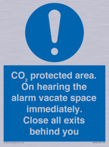 MN7906: CO₂ protected area. On hearing the alarm vacate space immediately. Close all exits behind you