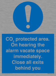 MN7906: CO₂ protected area. On hearing the alarm vacate space immediately. Close all exits behind you