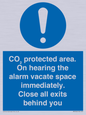 MN7906: CO₂ protected area. On hearing the alarm vacate space immediately. Close all exits behind you
