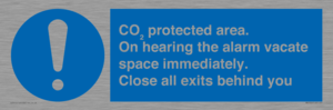 MN7906: CO₂ protected area. On hearing the alarm vacate space immediately. Close all exits behind you